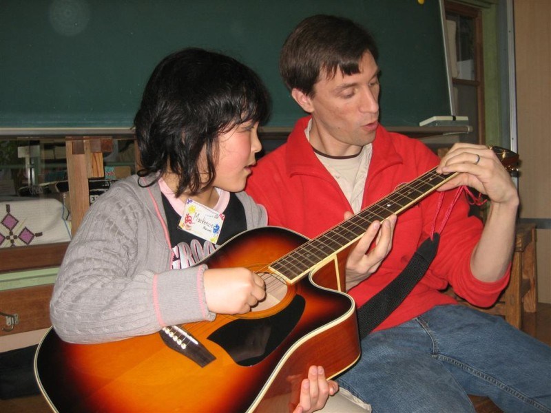 Playing guitar with student